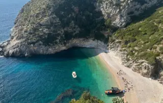 Grama Bay Boat Tour Grama Bay boat tour with turquoise waters and dramatic cliffs