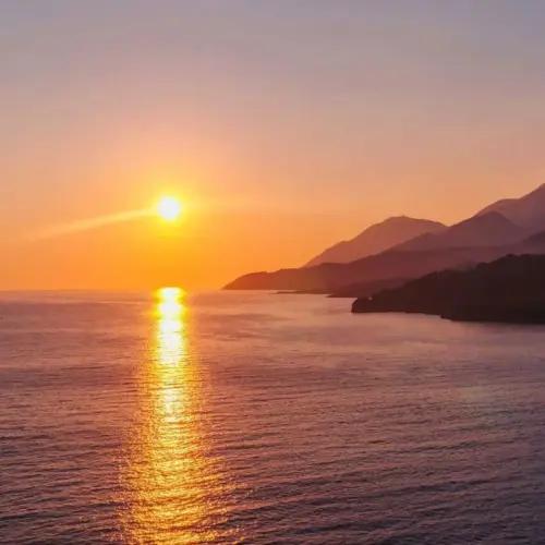 Sunset boat tour with golden sea views along Himara Coast