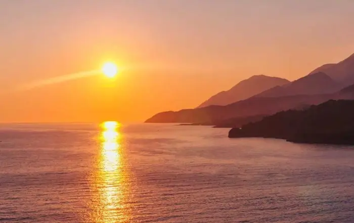 Sunset boat tour with golden sea views along Himara Coast