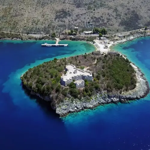 Porto Palermo boat tour with turquoise waters and historic castle views