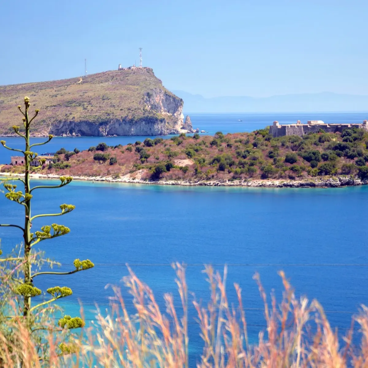 Porto Palermo boat tour with turquoise waters and historic castle views